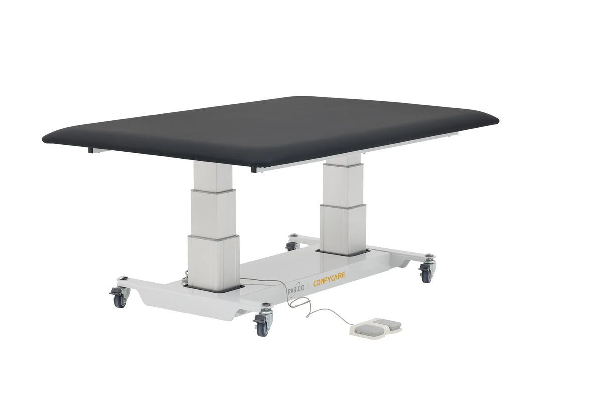 PARICO Coinfycare ELT100W bariatric hi-lo mat platform at raised height, three-quarter view with foot control